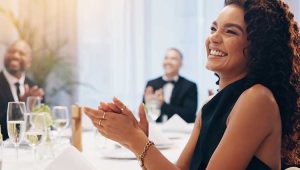 Woman applauding at a gala dinner