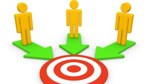 A cartoon image of three yellow figures standing on three green arrows pointing to a bullseye target. It illustrates the concept that financial advisors should form relationships with nonprofits.