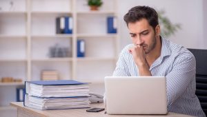 Concerned fundraising professional reading tax reform updates, reflecting nonprofit sector’s uncertainty after the One Big Beautiful Bill Act passed.