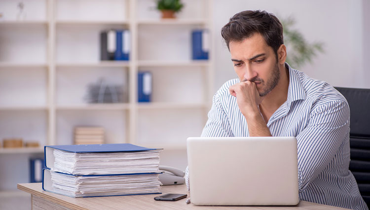 Concerned fundraising professional reading tax reform updates, reflecting nonprofit sector’s uncertainty after the One Big Beautiful Bill Act passed.