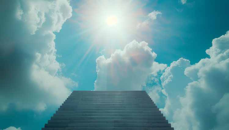 Stone stairway ascending through clouds toward bright sunlight